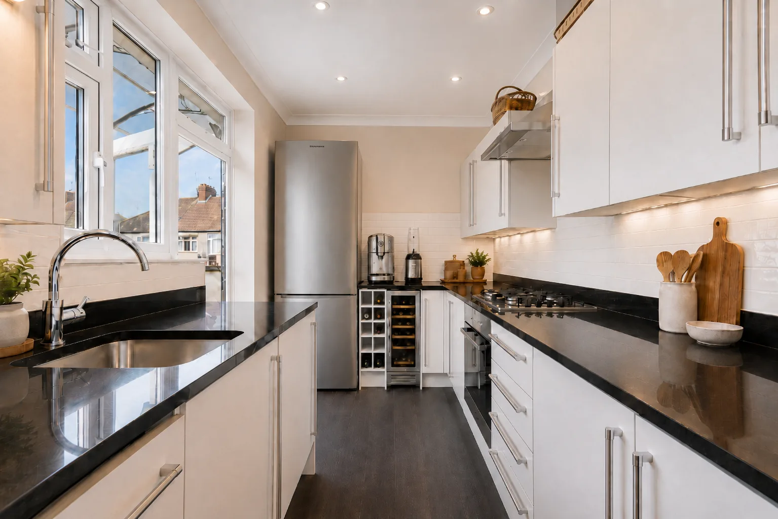 Minimalist kitchen with black counters and wine storage